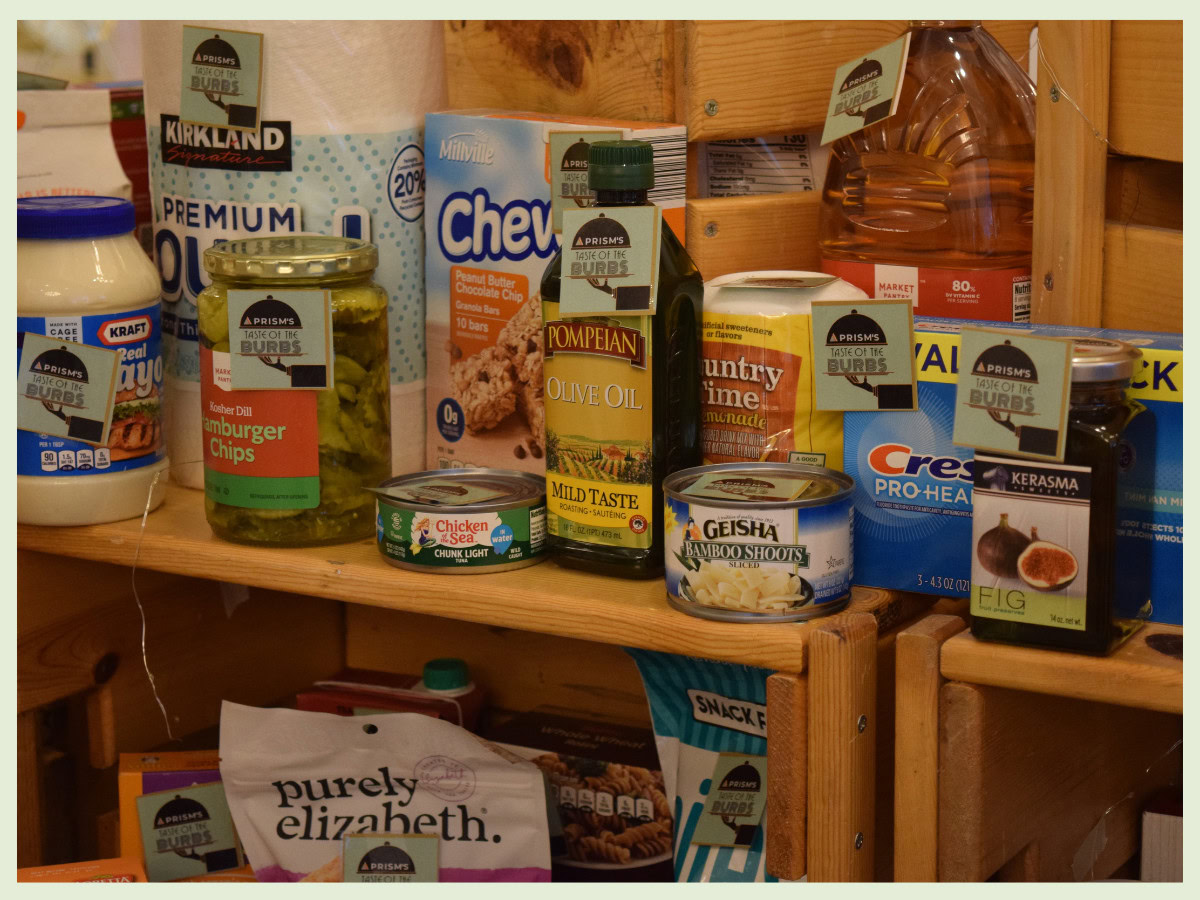 various food items stacked next to each other with green square tags on them with the Taste of the 'Burbs logo